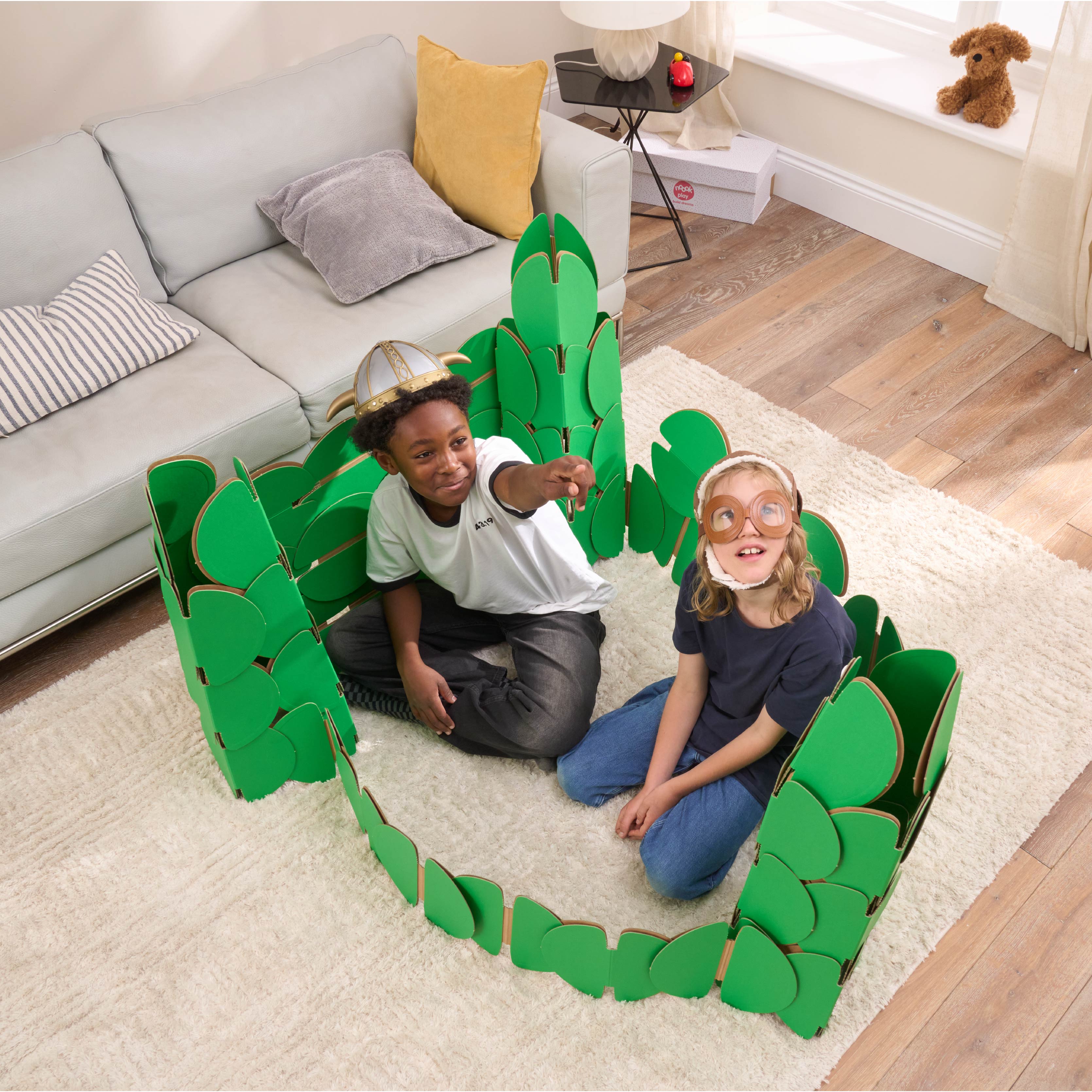 Two boys, in a living room, playing in a fort made out of a noook play® building kit.
This fort took 76 noook play® discs to build.