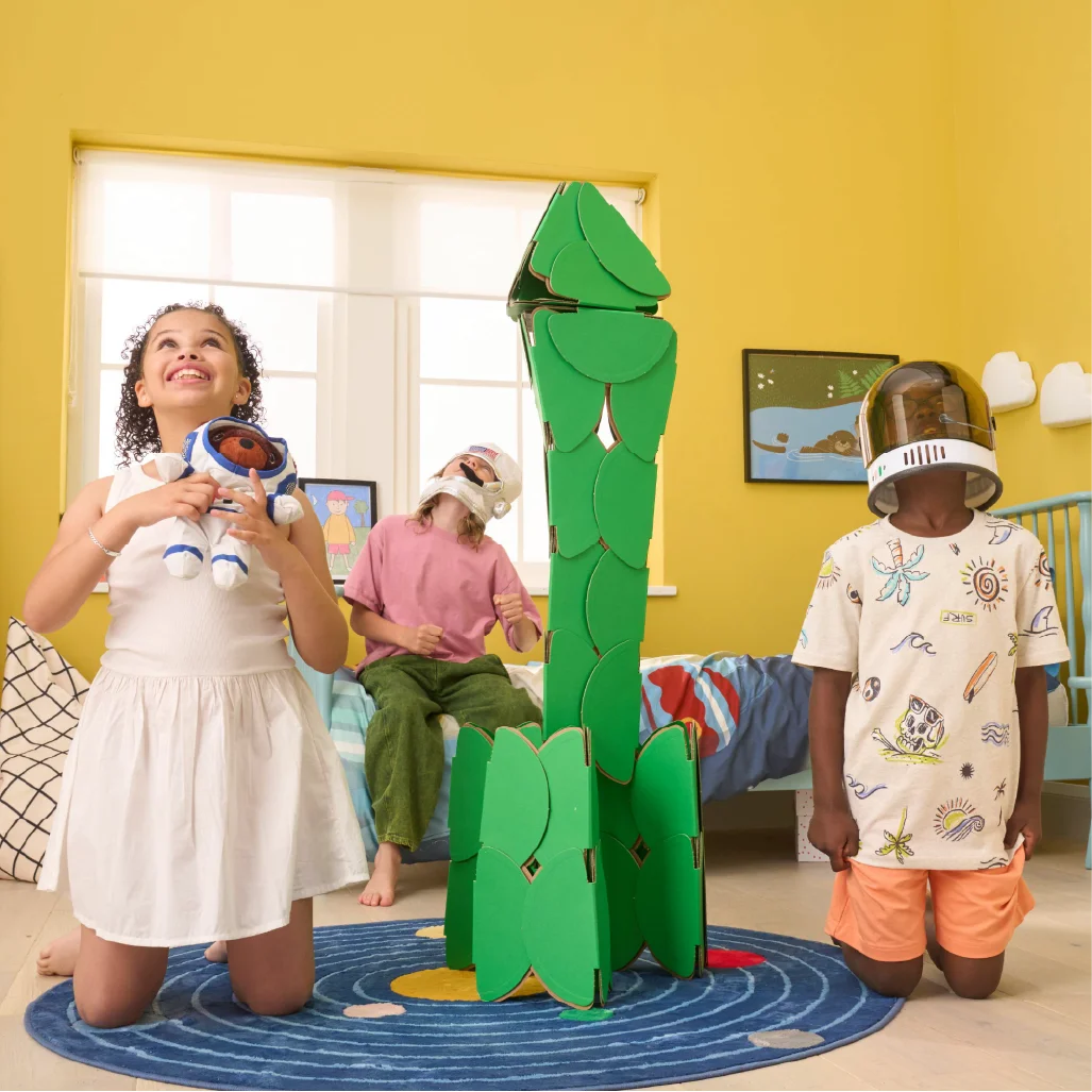 Three kids pretend to be astronauts by building a rocket made of a noook play® building kit. They're blasting off to an adventure in outer space!