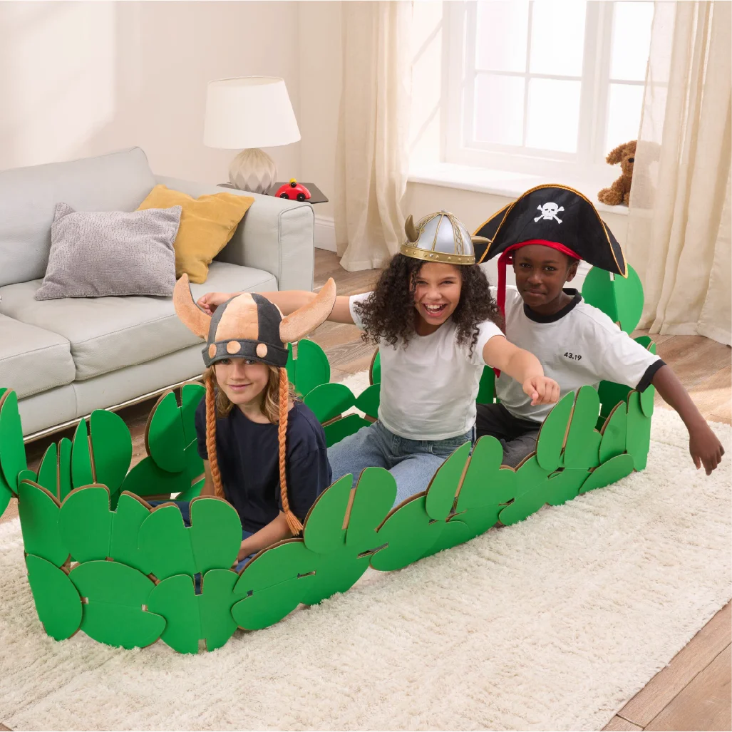 Three kids are playing in a sitting room, pretending to be Vikings on a raid. They're playing in a Viking longboat made of our a noook play® building kit. Two kids are wearing Viking horned helmets and one is wearing a Pirates' hat.
This Viking Longboat took 46 noook play® discs to build.