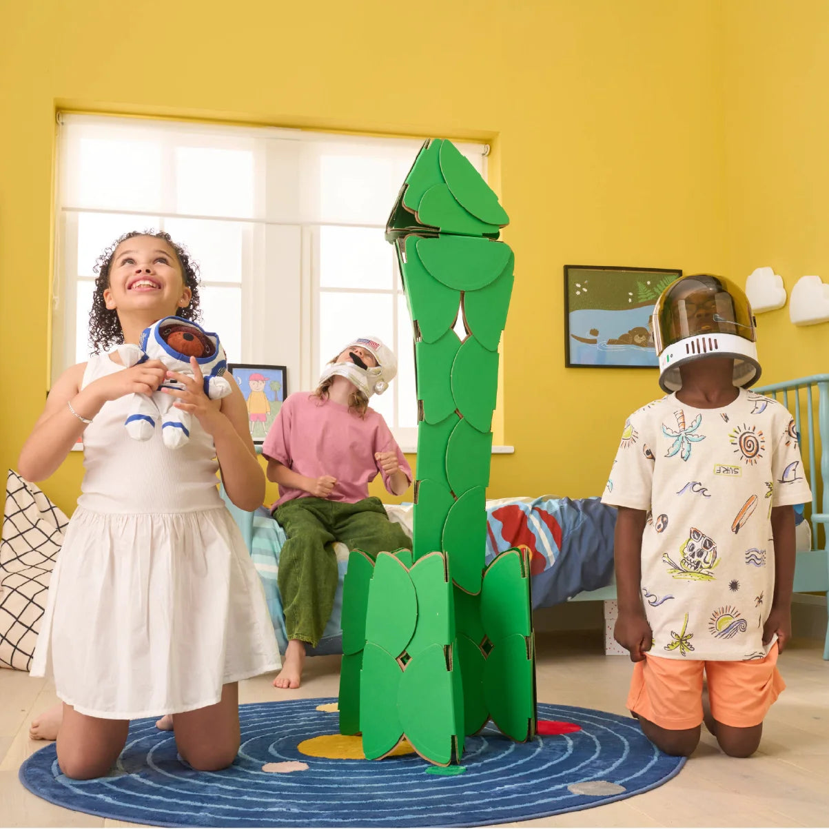 Three kids pretend to be astronauts by building a rocket made of a noook play® building kit. They're blasting off to an adventure in outer space!