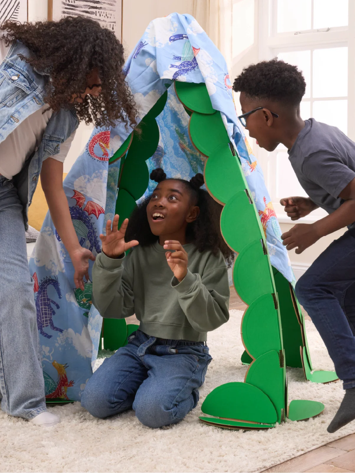 Three kids are playing in a living room, pretending to find dragons in a lair made out a noook play® building kit. The noook® den supports a sheet with dragons on.
This Dragon's Lair took 30 noook play® discs to build.