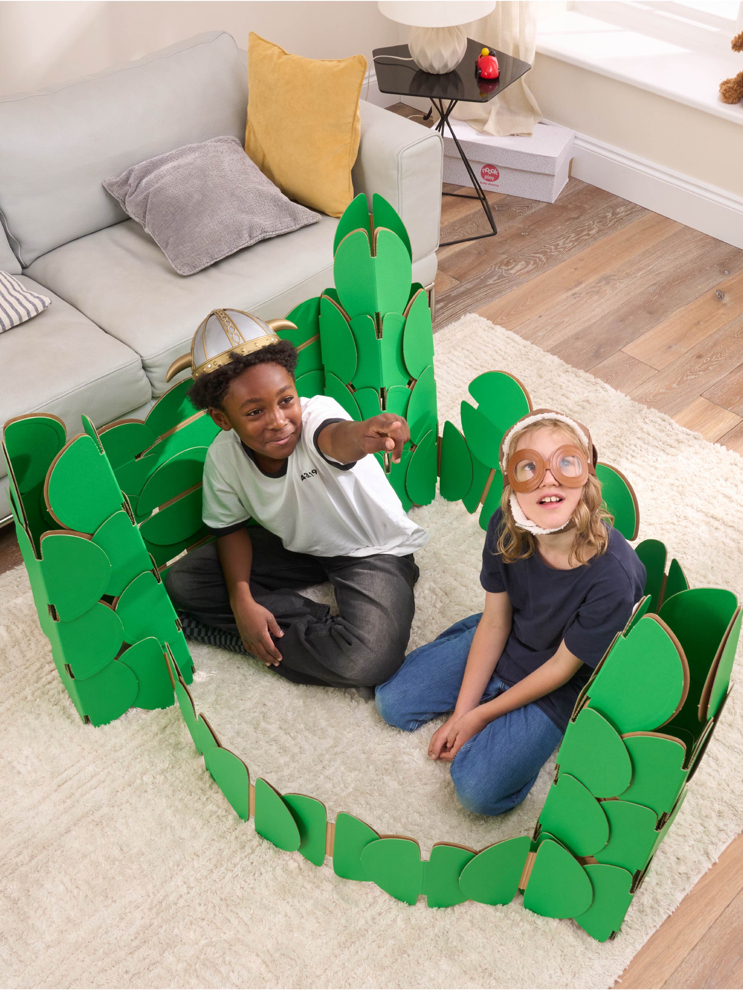 Two boys, in a living room, playing in a fort made out of a noook play® building kit.
This fort took 76 noook play® discs to build.