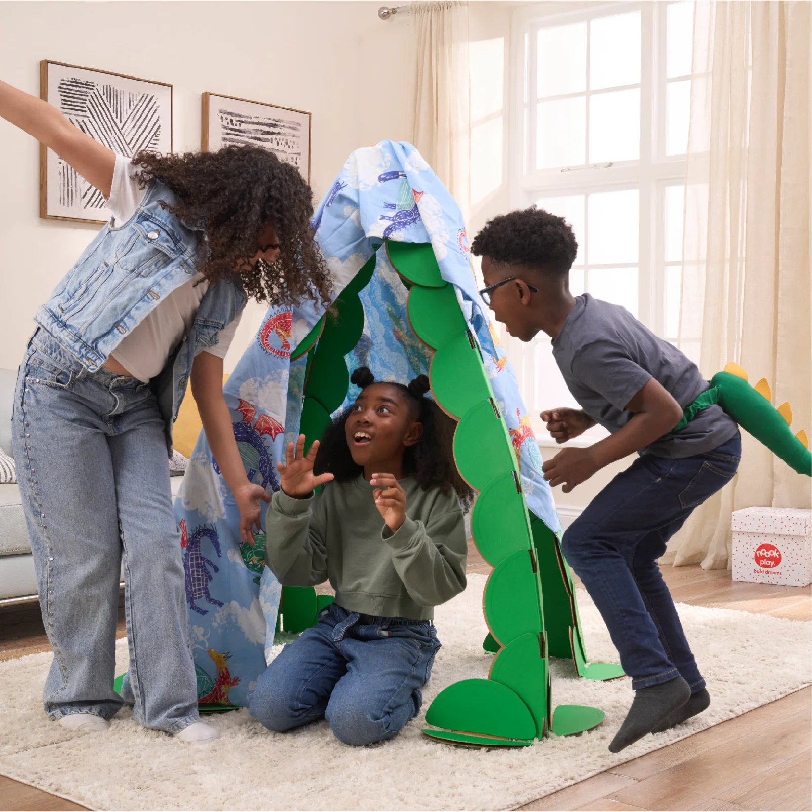Three kids are playing in a living room, pretending to find dragons in a lair made out a noook play® building kit. The noook® den supports a sheet with dragons on.
This Dragon's Lair took 30 noook play® discs to build.