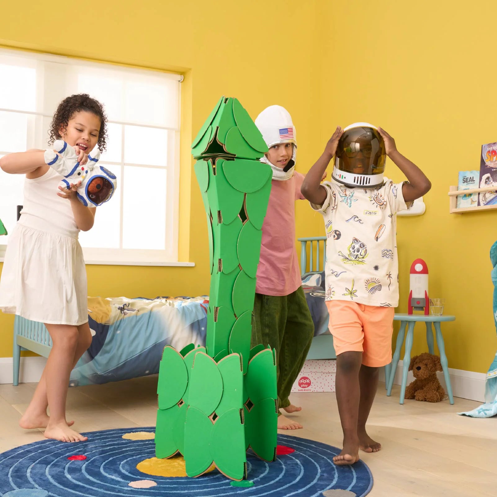 Children build a rocket with 40 noook play® discs, designing a life-sized structure for imaginative play