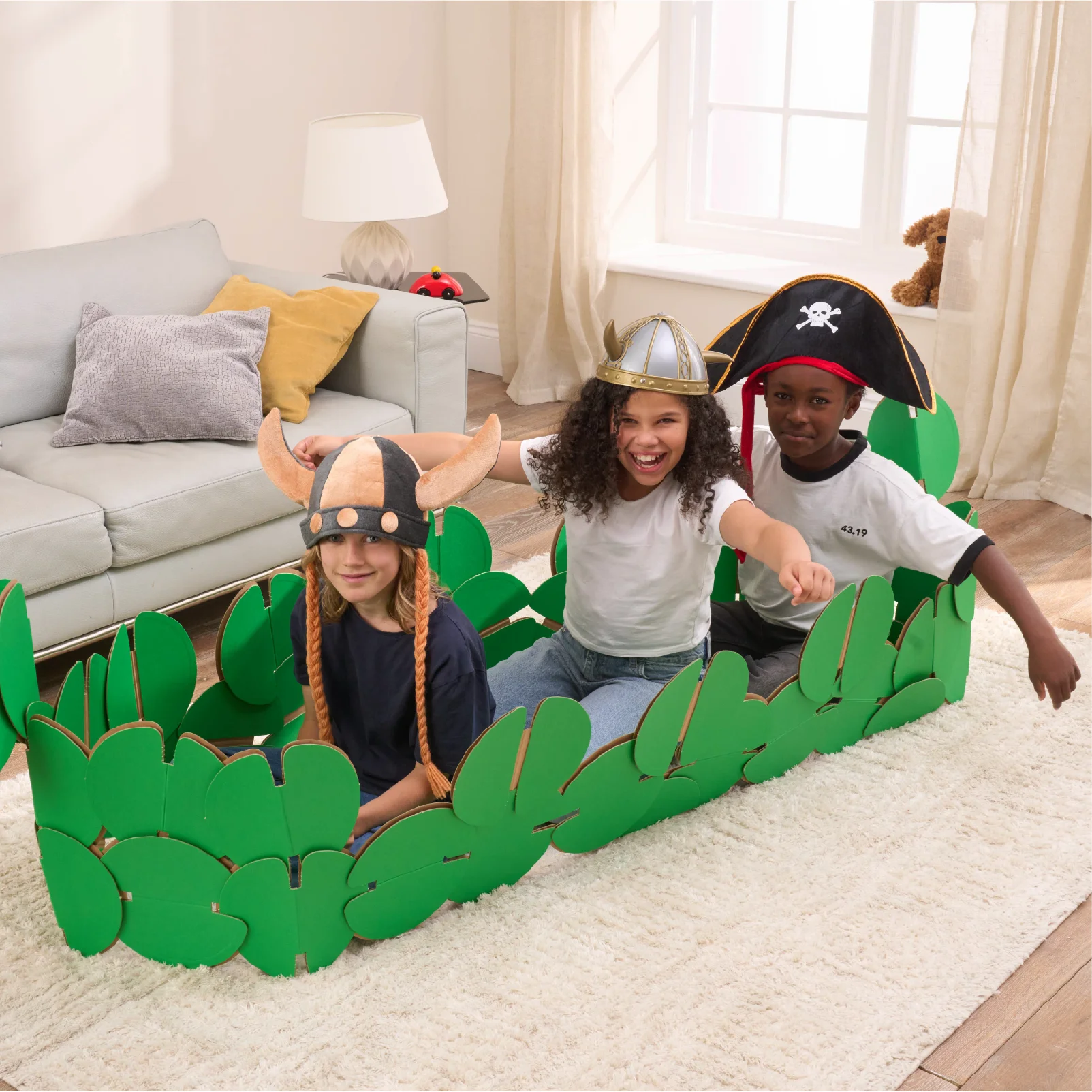 Three kids are playing in a sitting room, pretending to be Vikings on a raid. They're playing in a Viking longboat made of our a noook play® building kit. Two kids are wearing Viking horned helmets and one is wearing a Pirates' hat.
This Viking Longboat took 46 noook play® discs to build.