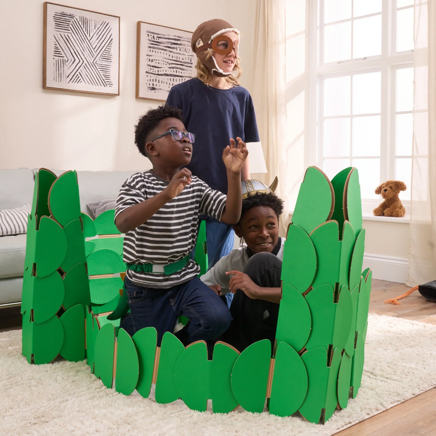 Three boys, in a living room, playing in a fort made out of a noook play® building kit.
This fort took 76 noook play® discs to build.