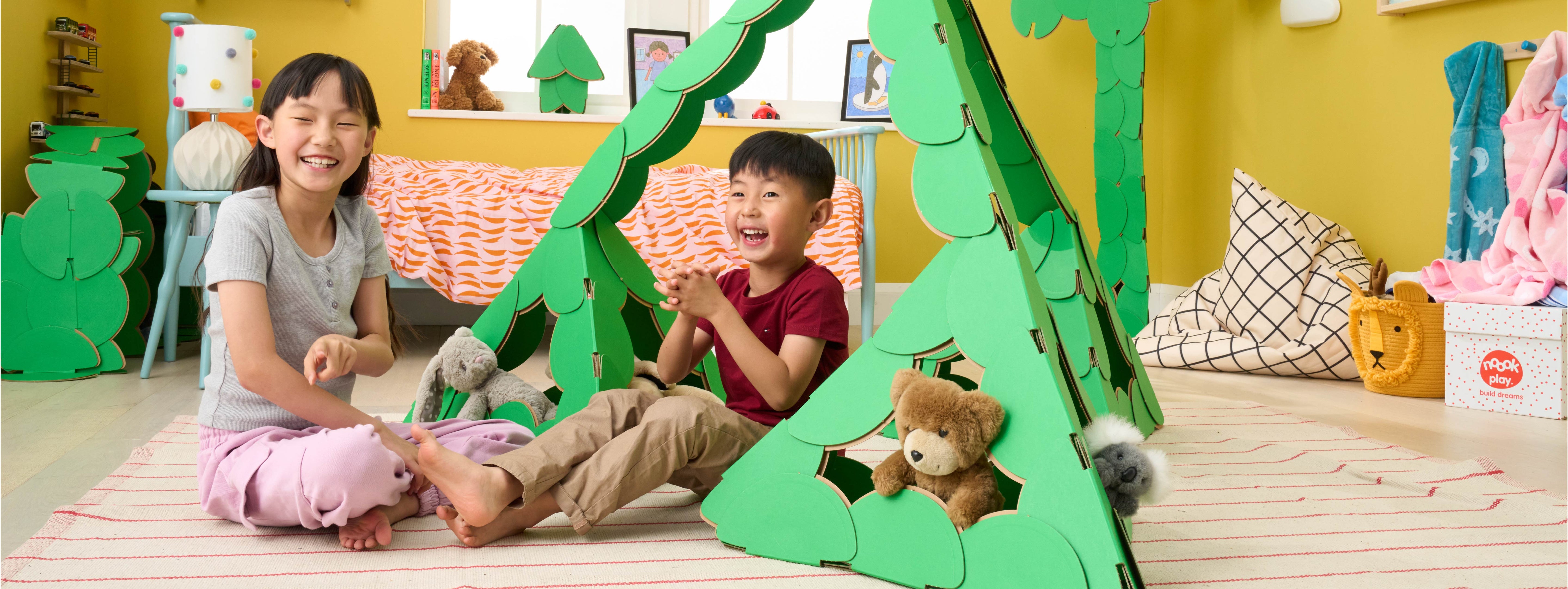 A brother a sister are playing 
with their teddy bears in a large pyramid made out of a noook play® building kit. Other objects in the children's' bedroom are also made of out of noook play® discs.
This pyramid took 69 noook play® discs to build.