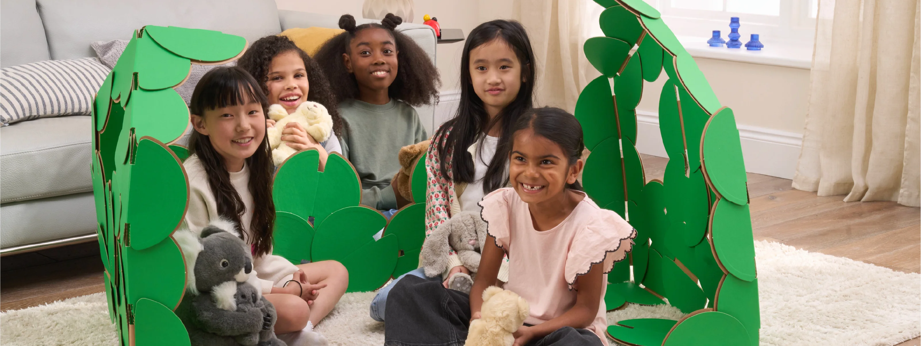 Five happy girls are having a party in a living room, with their teddies and a den made out of a noook play® building kit.
This Party House took 54 noook play® discs to build.