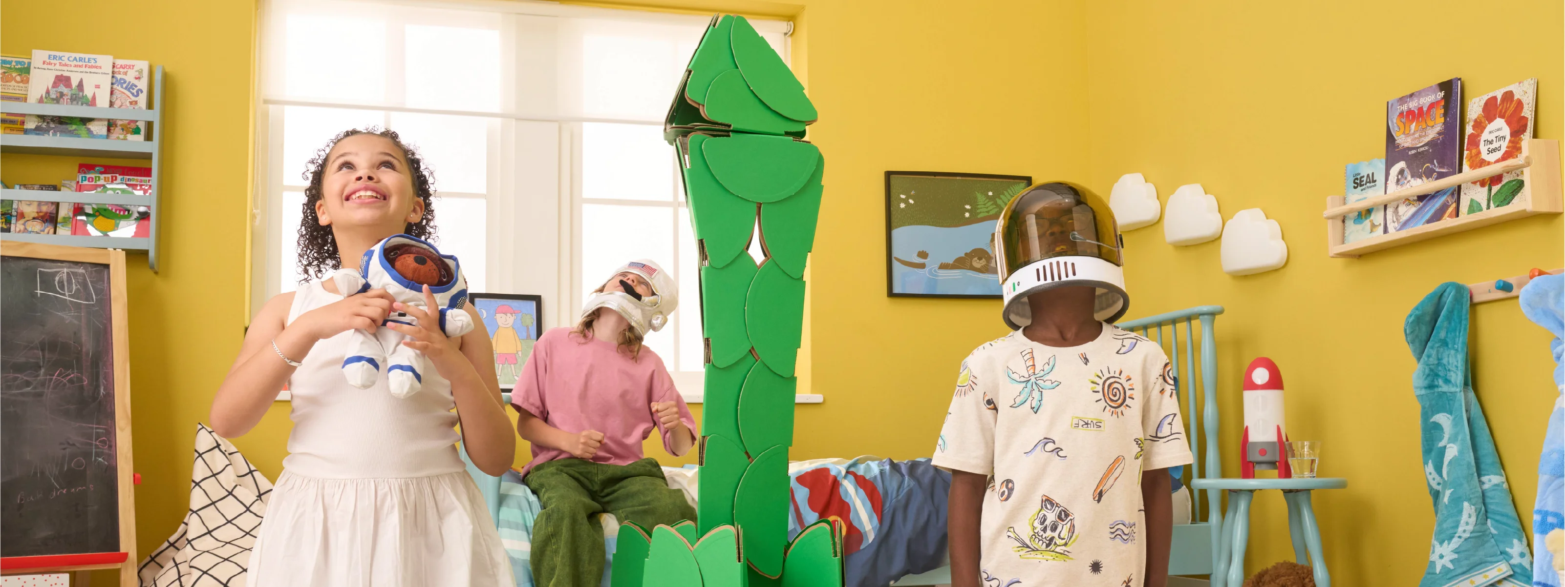 Three kids pretend to be astronauts by building a rocket made of a noook play® building kit. They're blasting off to an adventure in outer space!