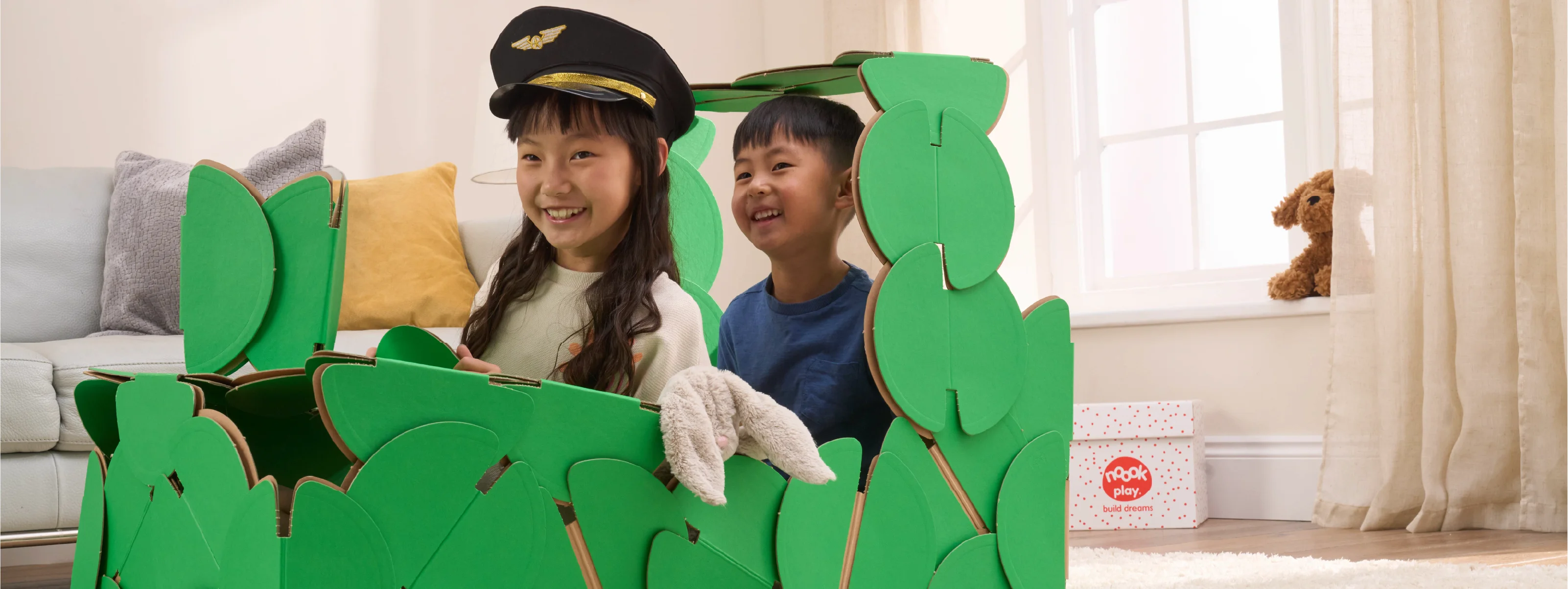 A brother and sister are playing train drivers in a steam train made out of a noook play® building kit.
This train took 51 noook play® discs to build.
