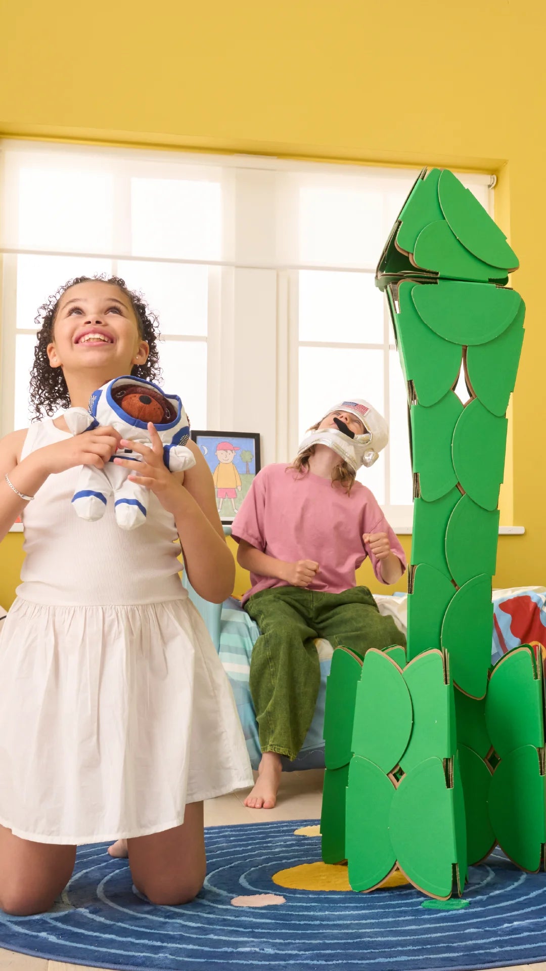 Children build a rocket with 40 noook play® discs, designing a life-sized structure for imaginative play