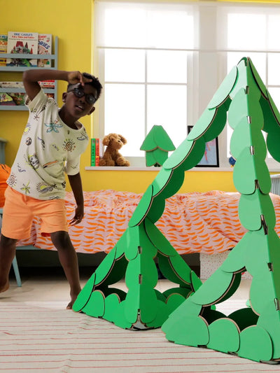 Children build and play with noook play® discs, creating large imaginative structures together
